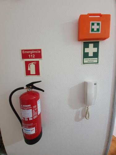 a fire extinguisher is hanging on a wall at Apartamento T2 Ansiães-Douro in Carrazeda de Anciães