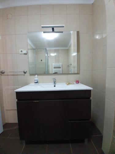 a bathroom with a sink and a mirror at Apartamento T2 Ansiães-Douro in Carrazeda de Anciães