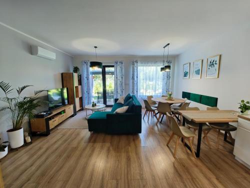 a living room with a couch and a dining room at Domek Zielone Marzenie in Chrzanów
