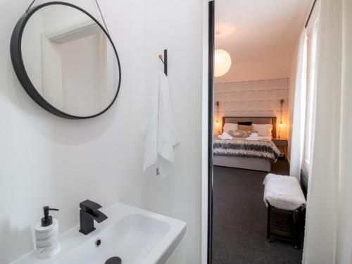 a bathroom with a sink and a mirror and a bed at Pass the Keys City Convenience in Stanley