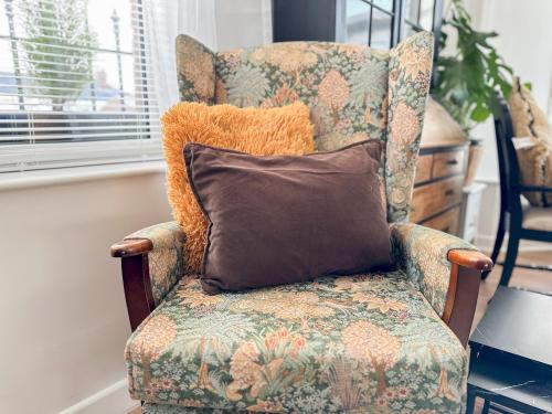 a chair with a pillow in a room at Pass the Keys City Convenience in Stanley