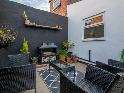 a patio with chairs and a fire place at Pass the Keys City Convenience in Stanley