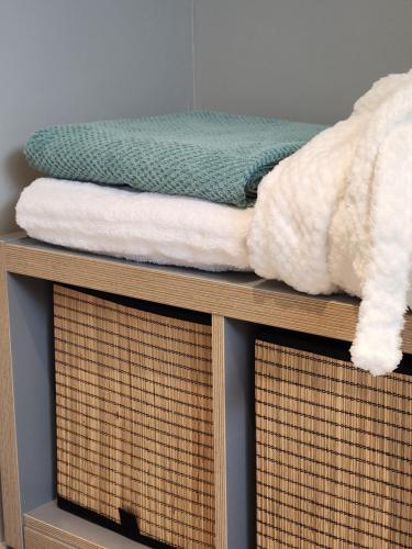 a pile of towels on top of a shelf at Lodge 323 in Malmedy