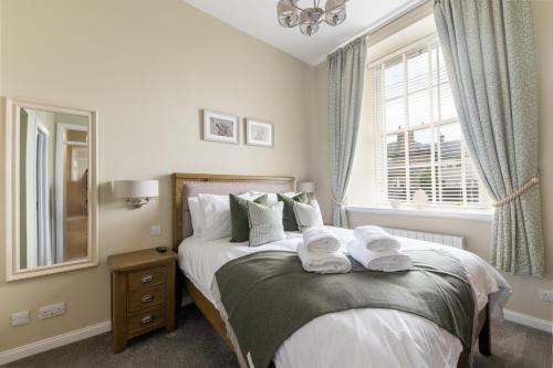 a bedroom with a bed with towels on it at Old Edinburgh Court in Inverness