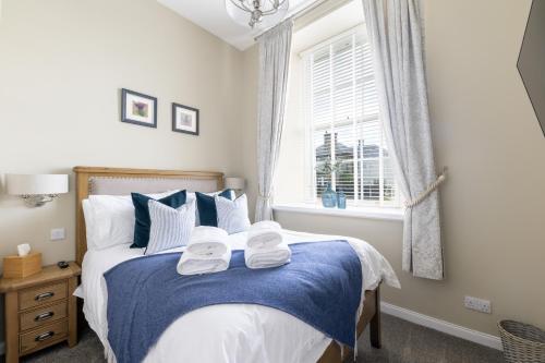 a bedroom with a bed with towels on it at Old Edinburgh Court in Inverness