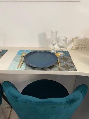 a table with a blue plate and glasses on it at Civico36 in Ilbono