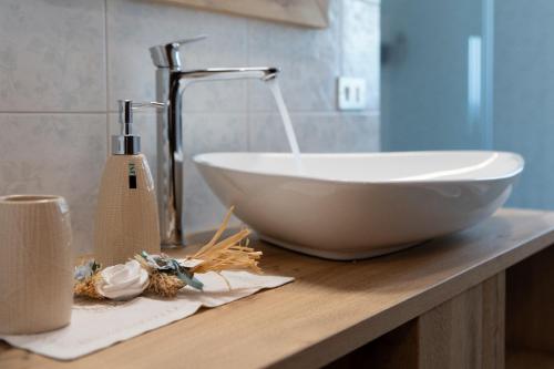 a white bowl on a counter with a sink at Al Calice in Fumane