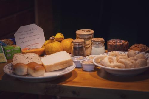 a table topped with plates of bread and other foods at Cabanas dos Plátanos in Gramado