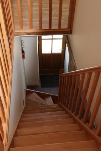 a staircase in a house with a wooden ceiling at Amazing renovated Loire Valley gite in La Pellerine