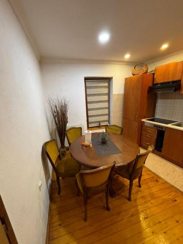 a kitchen with a table and chairs in a room at Luni in Travnik