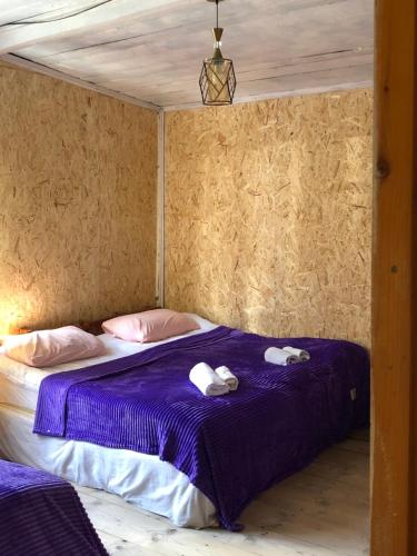 a room with a bed with two towels on it at Ela in Ushguli