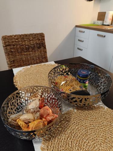 two baskets on a table with food in them at Alloggio Albaluna in Dronero