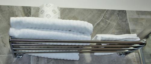 a stack of towels on a towel rack in a bathroom at Have A Nice Holiday - Luxury Rooms in Rome