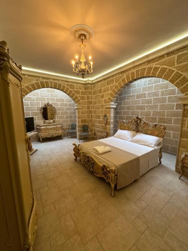 a bedroom with a large bed in a brick wall at Castlehawk Resort in Galatone