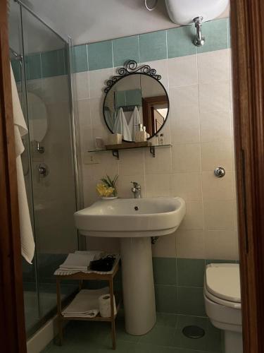 a bathroom with a sink and a shower and a mirror at B&B Colle Cucchiara in Cassino