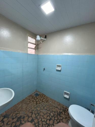 a bathroom with a toilet and a sink at Hotel Centro in Corumbá