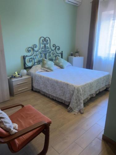 a bedroom with a large bed and a chair at B&B Colle Cucchiara in Cassino