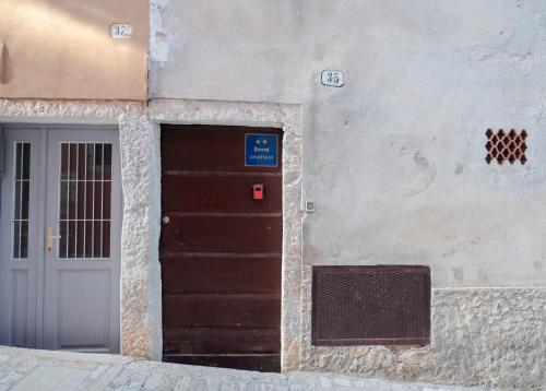 a building with a door next to a door at Fiammetta in Rovinj