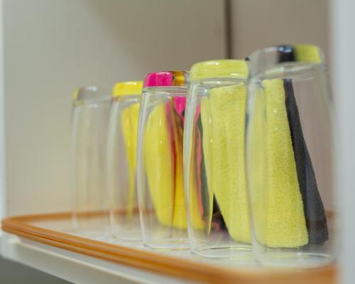 a group of glass vases sitting on a shelf at Aseda by Judisol Apartments in Kwedonu