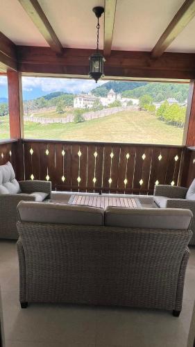 a room with a couch and a large window at Casa Tudorescu in Horezu