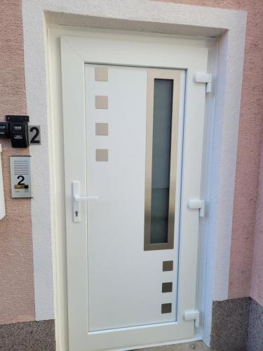 a white door on the side of a building at TWO Self-Check-In, 3km freeway, Free-Parking Playstation in Wolfpassing an der Hochleithen