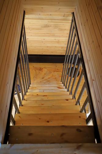 a staircase in a cabin with wooden flooring at Hotel Twins Surami in Surami