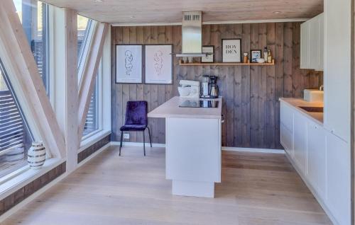 a kitchen with a counter and a purple chair at Stunning Home In Hovden I Setesdal in Hovden