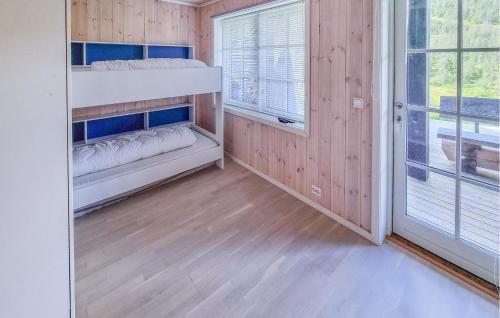 a bedroom with two bunk beds and a window at Stunning Home In Hovden I Setesdal in Hovden
