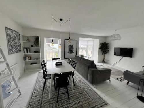 a living room with a table and a couch at A stunning 2 bed apartment in Fishguard