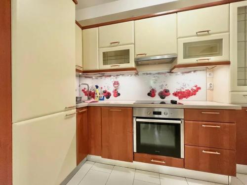a kitchen with wooden cabinets and a white refrigerator at Matija i Luka in Bijela