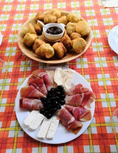 a plate of food on a table with a plate of food at Serenity Village Cottage with outside toilet in Balabani