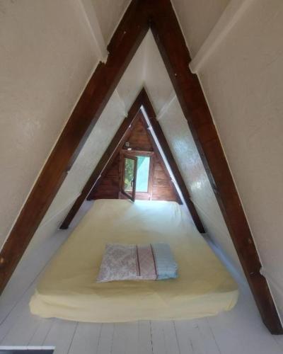 a room with a bed in the attic at Serenity Village Cottage with outside toilet in Balabani