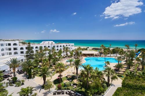 an aerial view of a resort with a pool and the ocean at Nozha Beach Resort & Spa in Hammamet