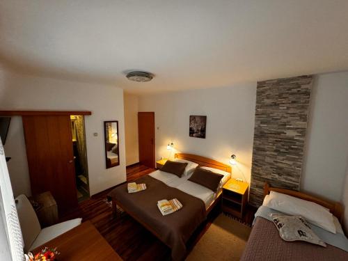 a hotel room with a bed and a fireplace at Guest House Family Varda Plitvice Lakes in Plitvička Jezera
