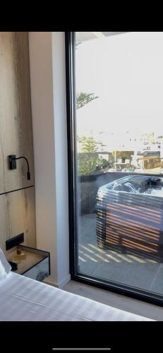 a bedroom with a view of a car outside a window at Hotel Joni Premium in Ksamil