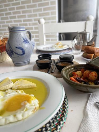 a table with plates of food and a bowl of food at Casa Marwan in Tetouan