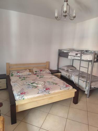 a bedroom with two bunk beds and a chandelier at Erald Apartment 2 Bedrooms in Shëngjin