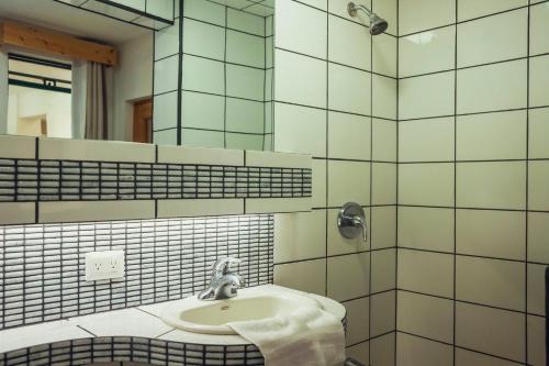 a bathroom with a sink and a mirror at El Dragon Hotel in San Marcos La Laguna