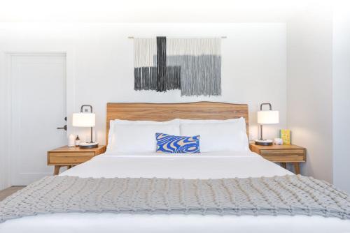 a bedroom with a large bed with two night stands at Laguna Surf Lodge by SCP Hotels in Laguna Beach