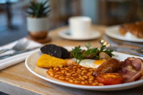 un plato de comida con huevos salchichas frijoles y maíz en The Malvern Hills Hotel, en Great Malvern