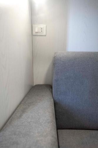 a small room with a bed and a lightswitch at Prestige House 6 in Scalea