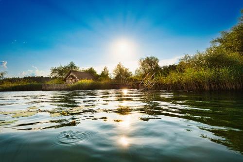 a view of a river with a house in the background at Seehaus Herzog in Drobollach am Faakersee