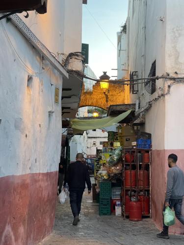 a man walking through an alleyway in a city at Casa Marwan in Tetouan