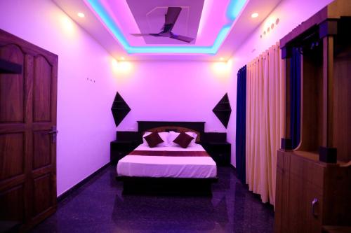 a bedroom with a bed with purple lights on it at Hillsidecreek Homestay in Anachal