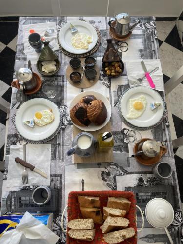 a table with plates of breakfast food on it at Casa Marwan in Tetouan