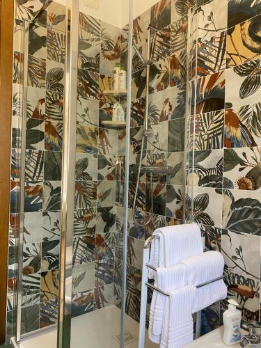 a bathroom with a shower and a white towel at Green Nest in Farra di Soligo