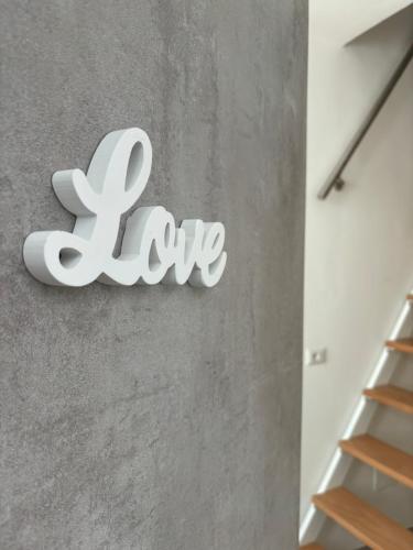 a sign that says love on a wall at L'arco di porta Lecce in Brindisi