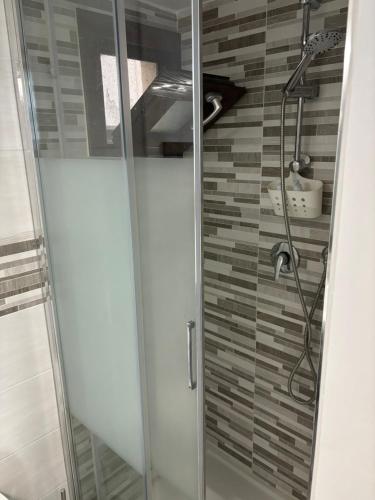a shower with a glass door in a bathroom at L'arco di porta Lecce in Brindisi
