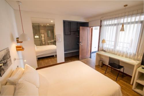 Postel nebo postele na pokoji v ubytování Cosmopolitano Hotel Boutique