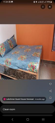 a bedroom with a bed with a blue comforter at Laxman Guest House varanasi in Varanasi
